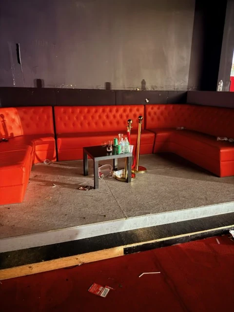 Red booth seating before cleanup