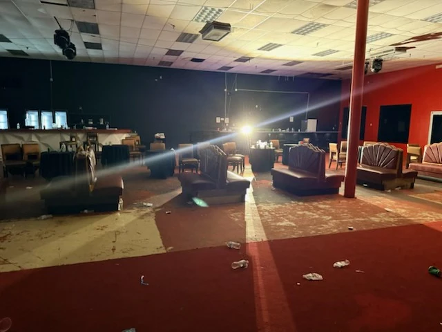 Venue entrance and lounge with post-event litter on the floor