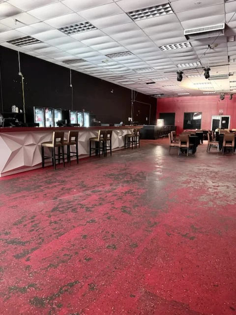 Cleared lounge floor with tables arranged along the room