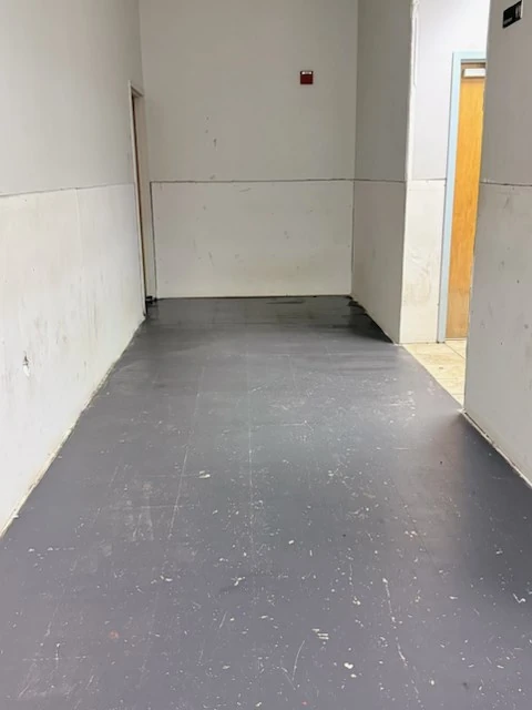 Cleared venue hallway with gray flooring