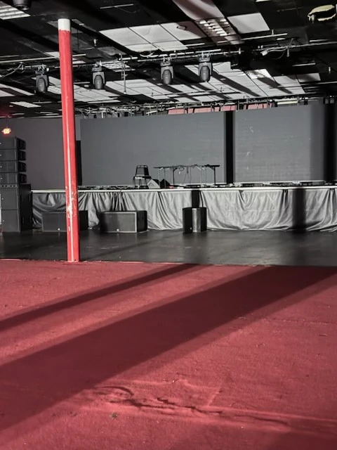 Cleared dark stage floor and adjoining red carpet
