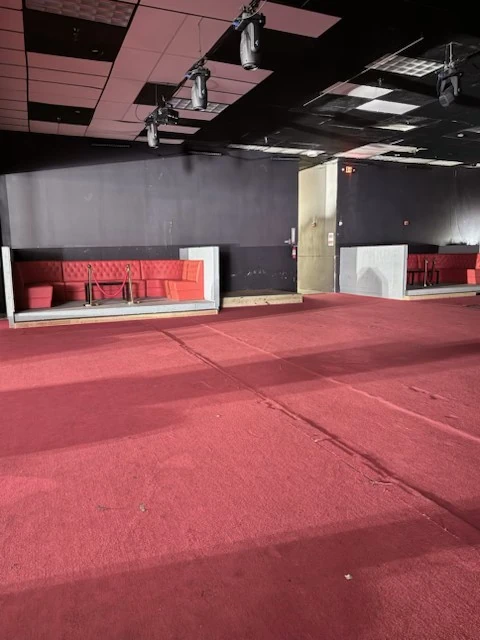 Red booth seating and adjoining cleared event floor